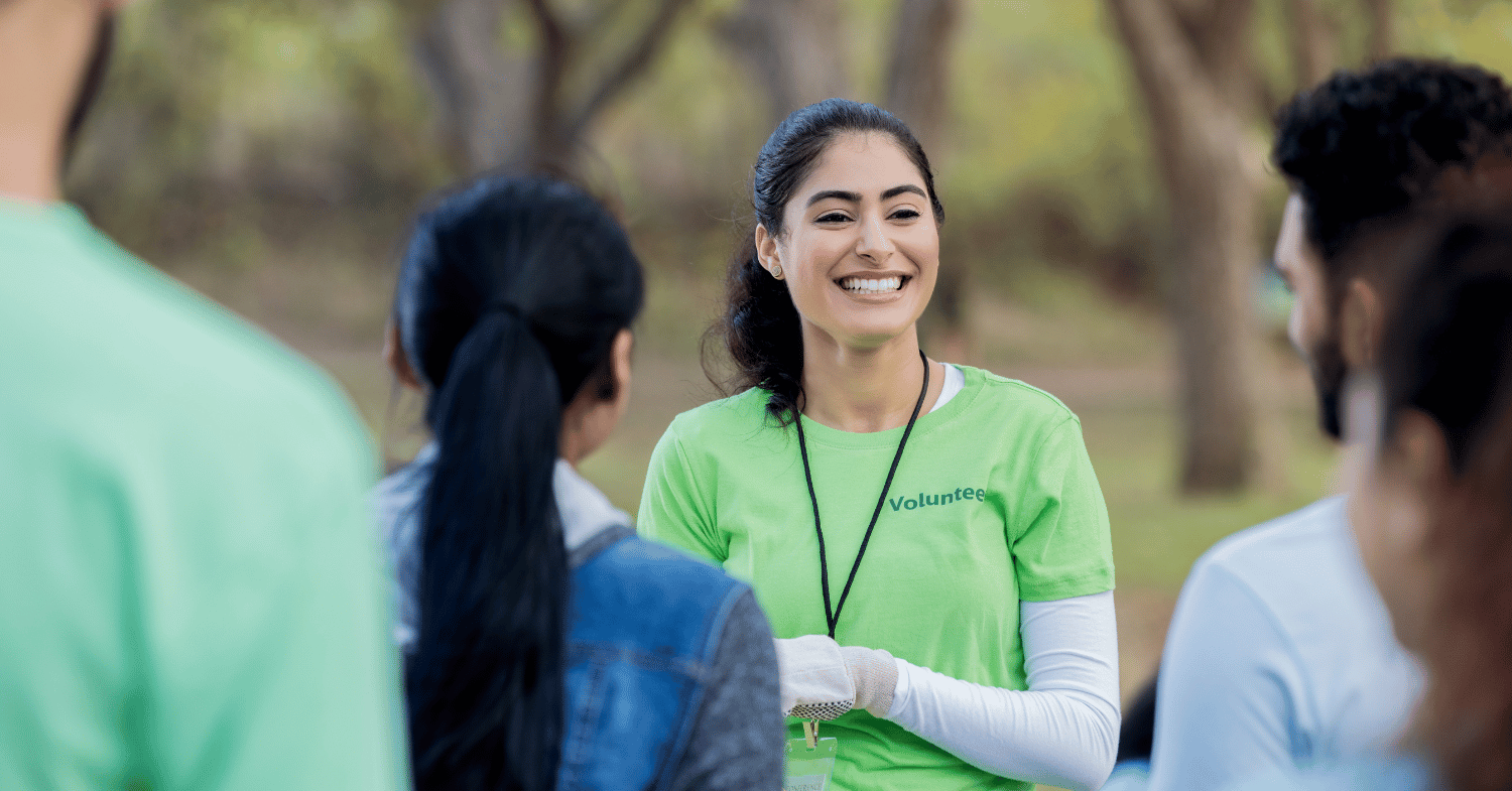 A female volunteer wearing a green tshirt, smiling