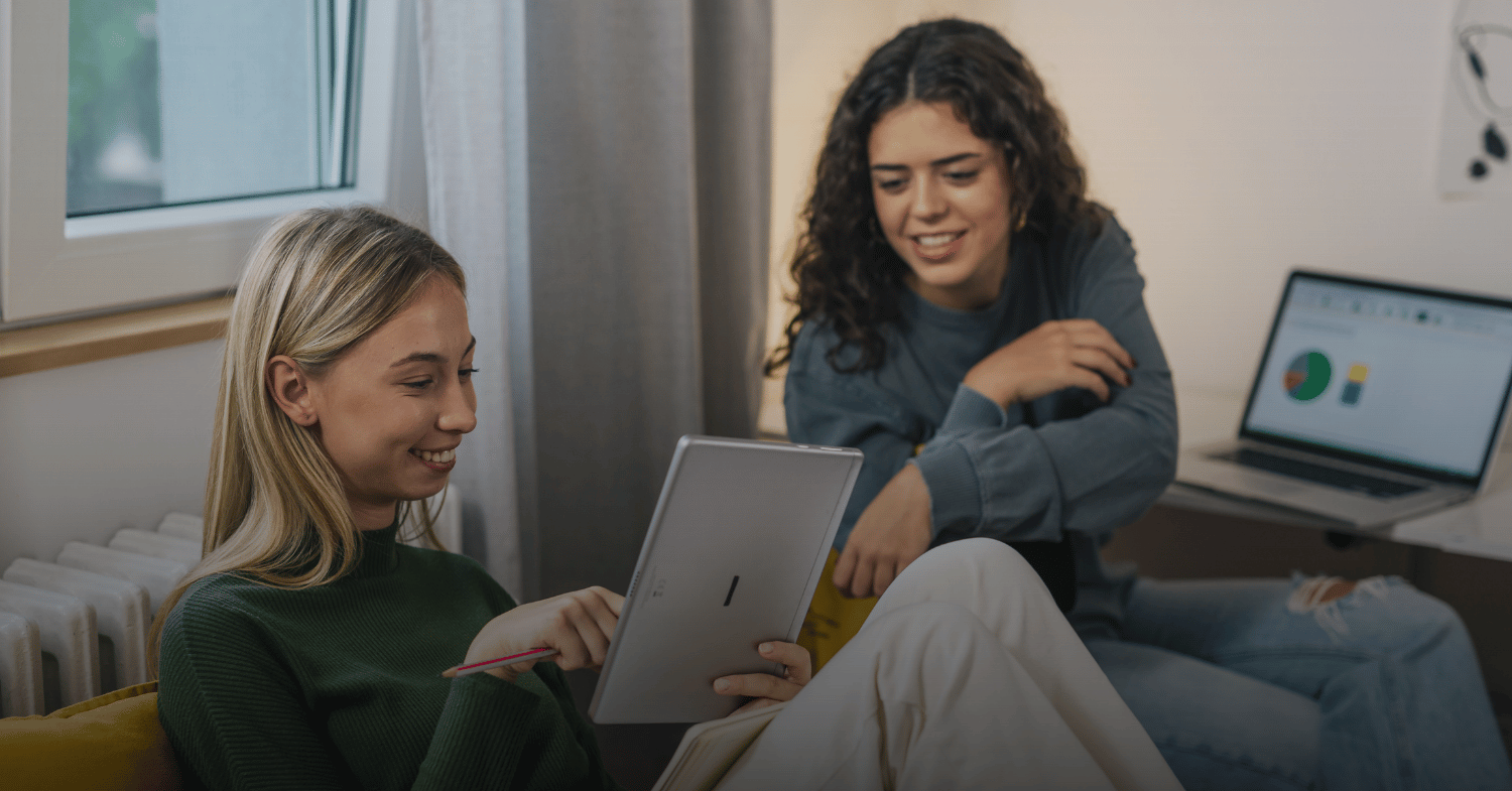 Two female students looking at a tablet