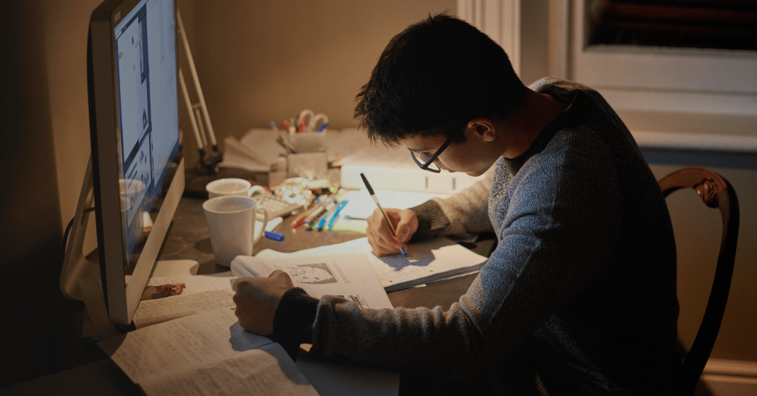 Male student studying at night time